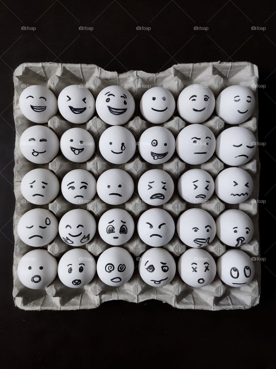 Tray of eggs with different emotions.