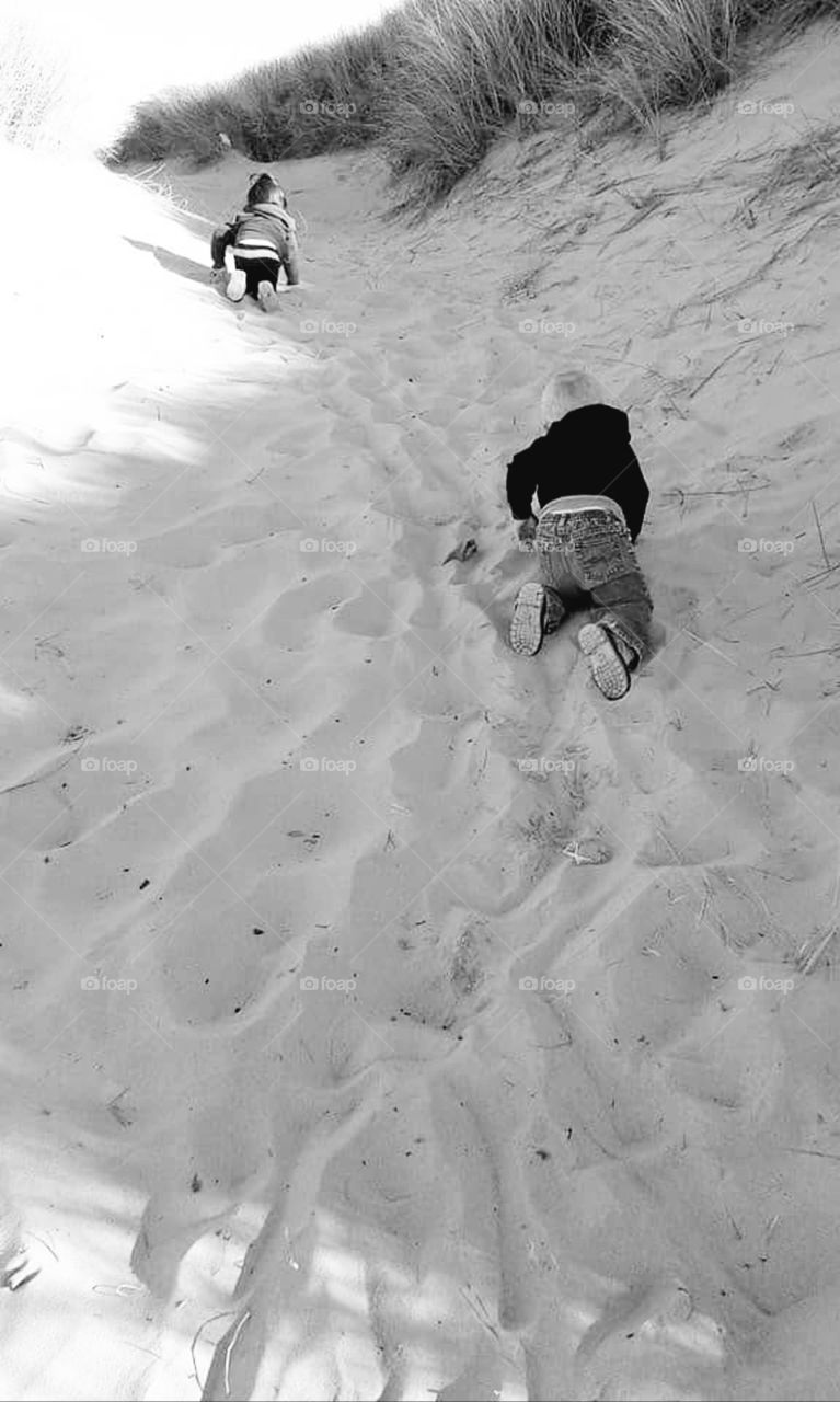 toddlers crawling up the dunes