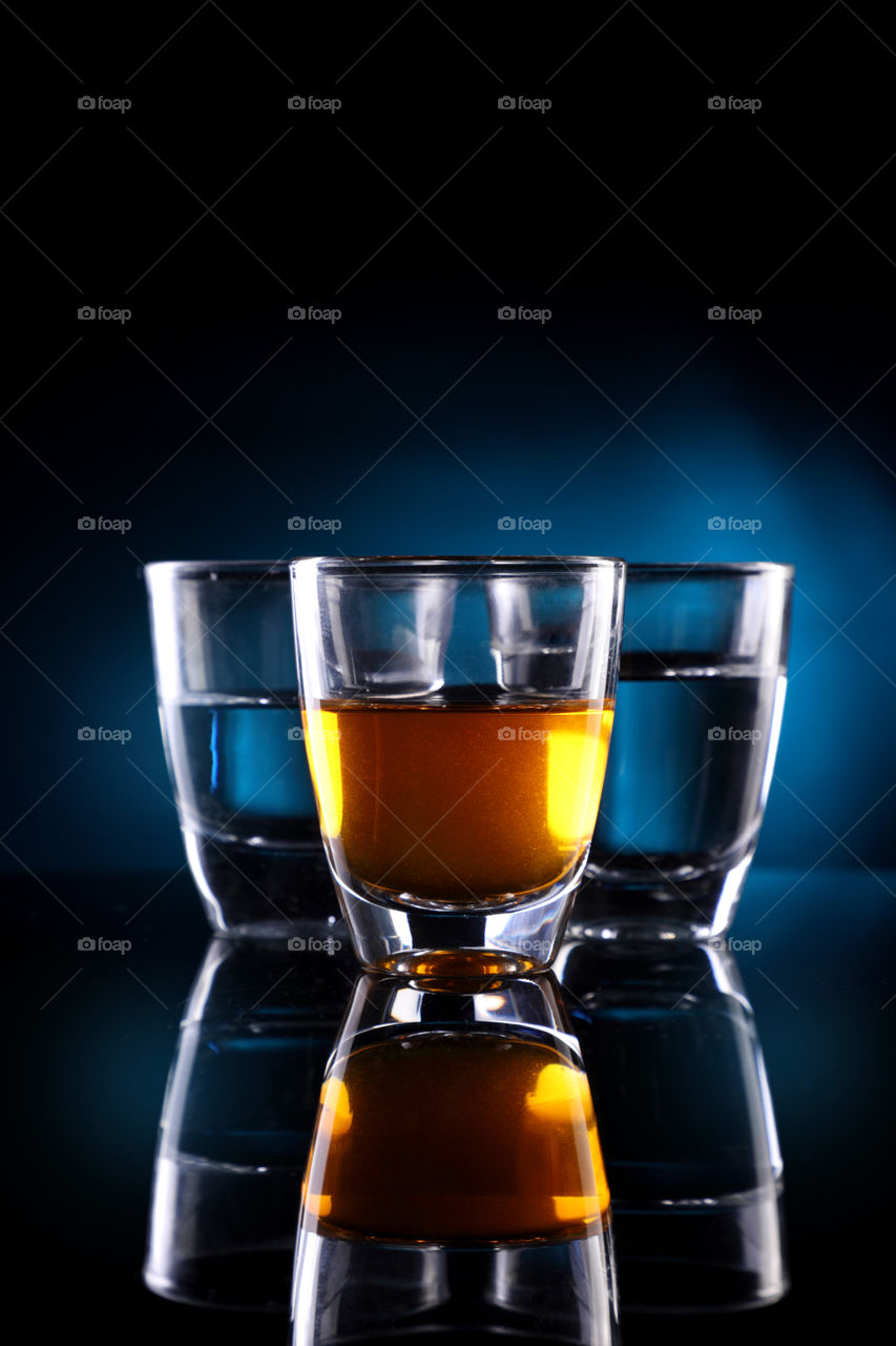 Shot glasses with dark blue background