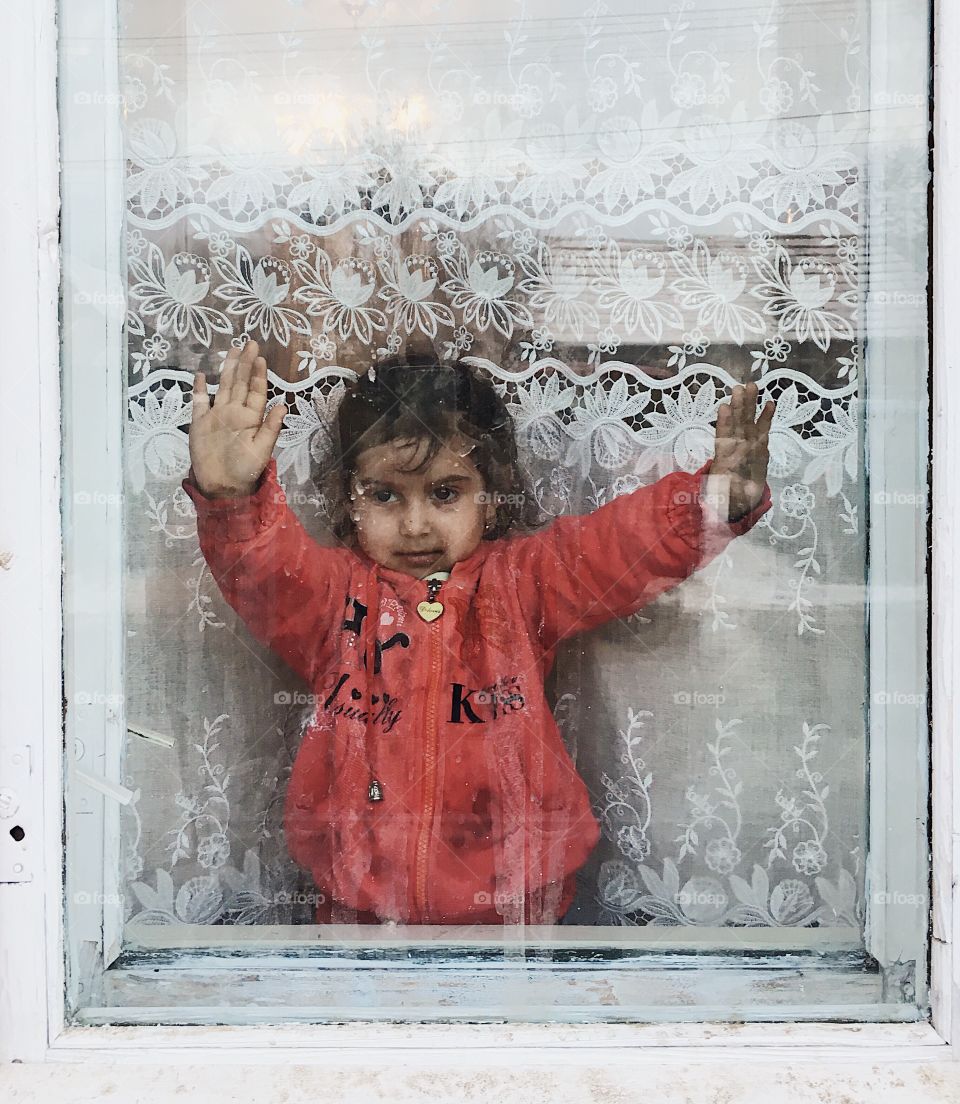 Cute girl standing near window