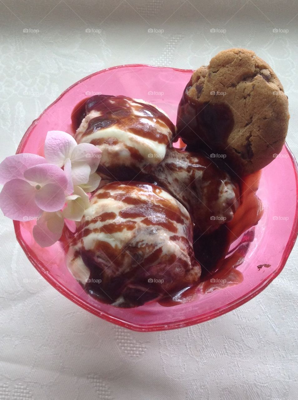 Vanilla ice cream with chocolate syrup drizzled on top.