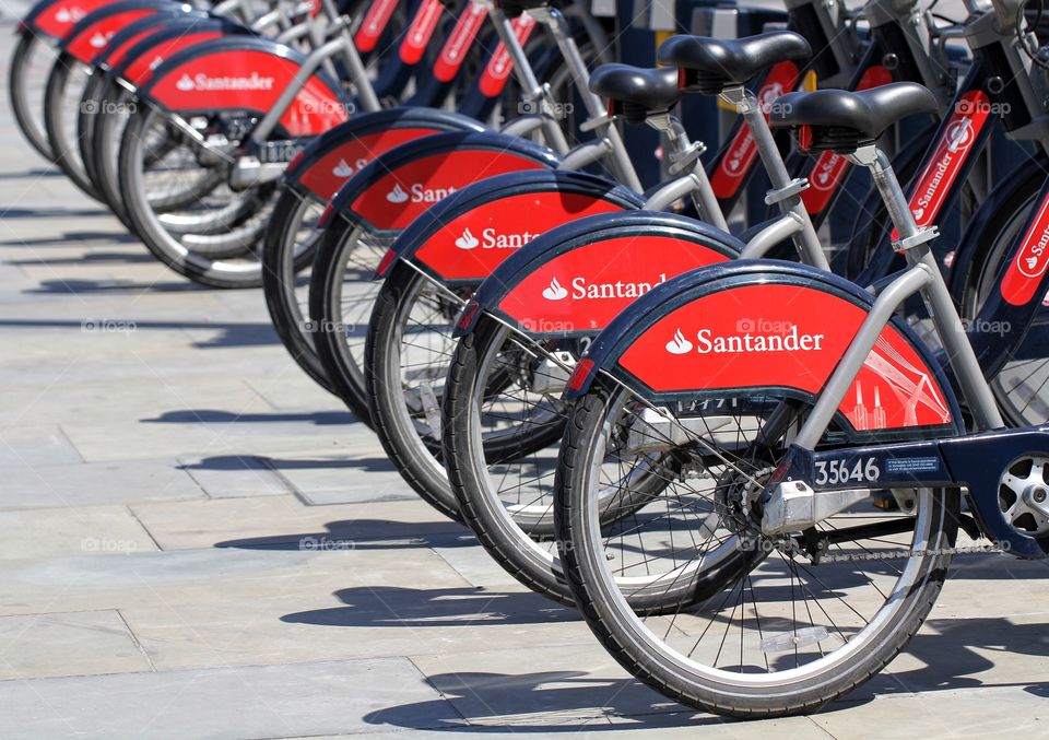 A row of Santander sponsored bikes from London's popular bicycle hire scheme. The bikes are also known as Boris bikes after the Mayor Of London, Boris Johnson.