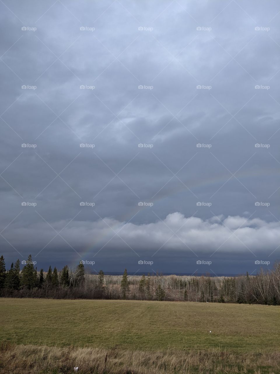 Rainbow and dàrk clouds.