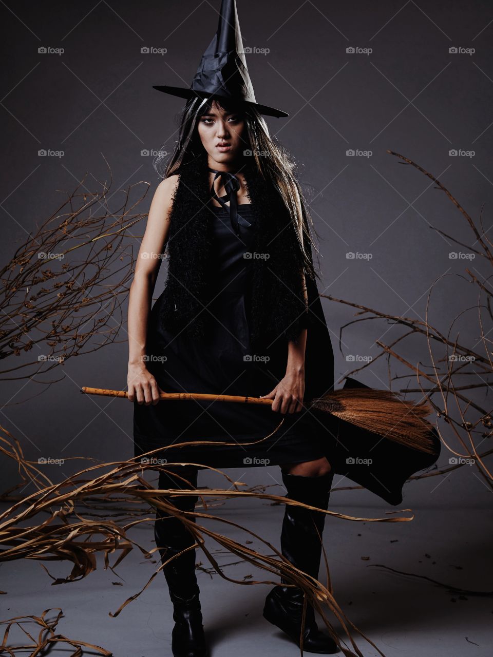 Woman modeling in witch costume for Halloween 
