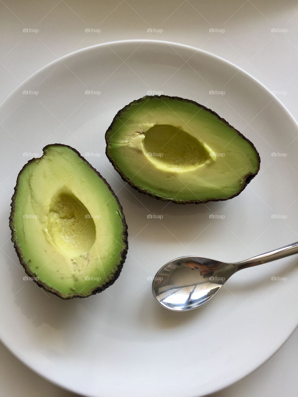 Avocado halves w/ spoon