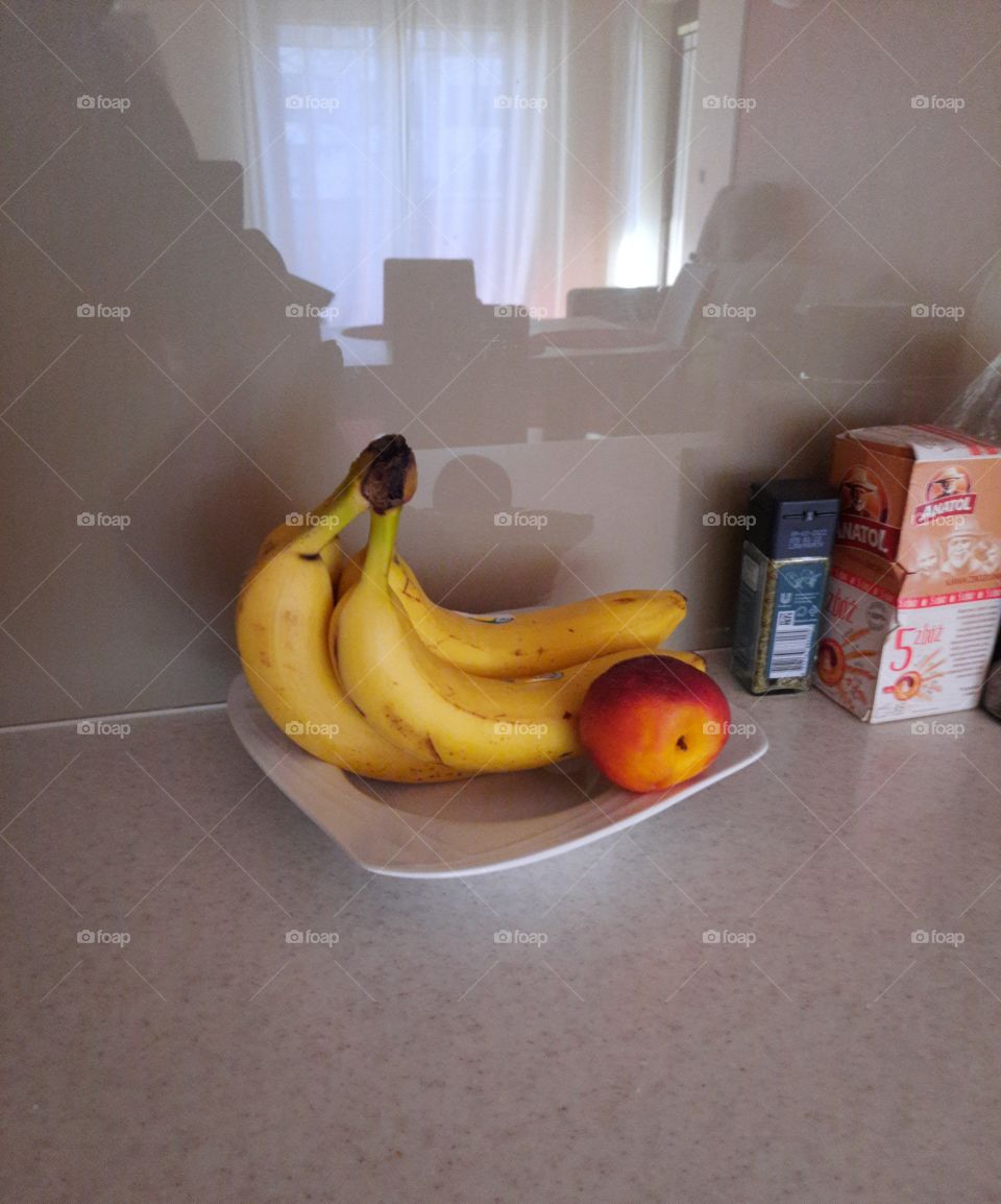 fruits on a plate with reflection of the room and window