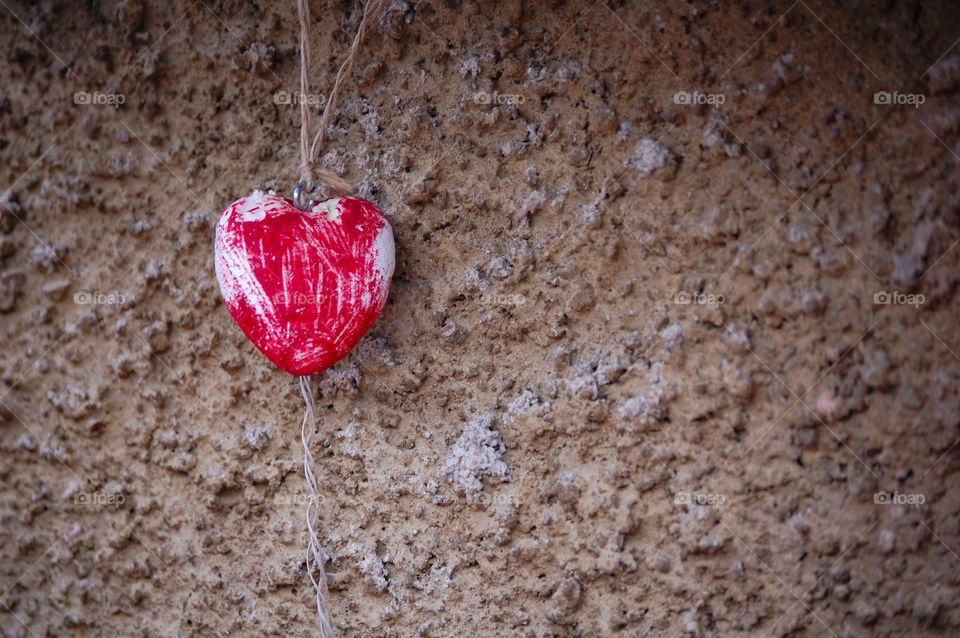 Photo of a decorative red wooden heart on outdoor 