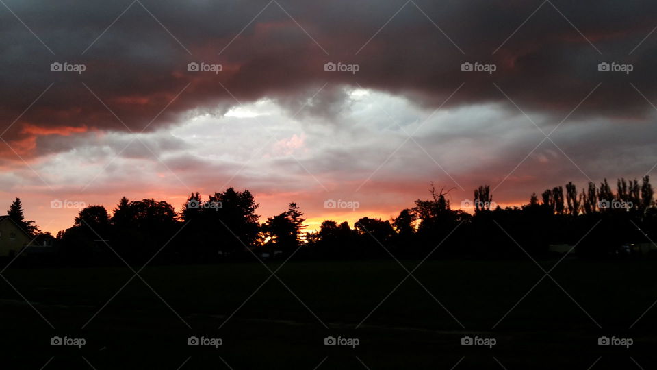 red yellow sunset with thunderstorm coming up in berlin.