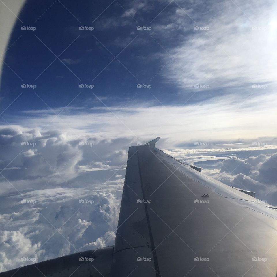 A view of the clouds from a plane window.