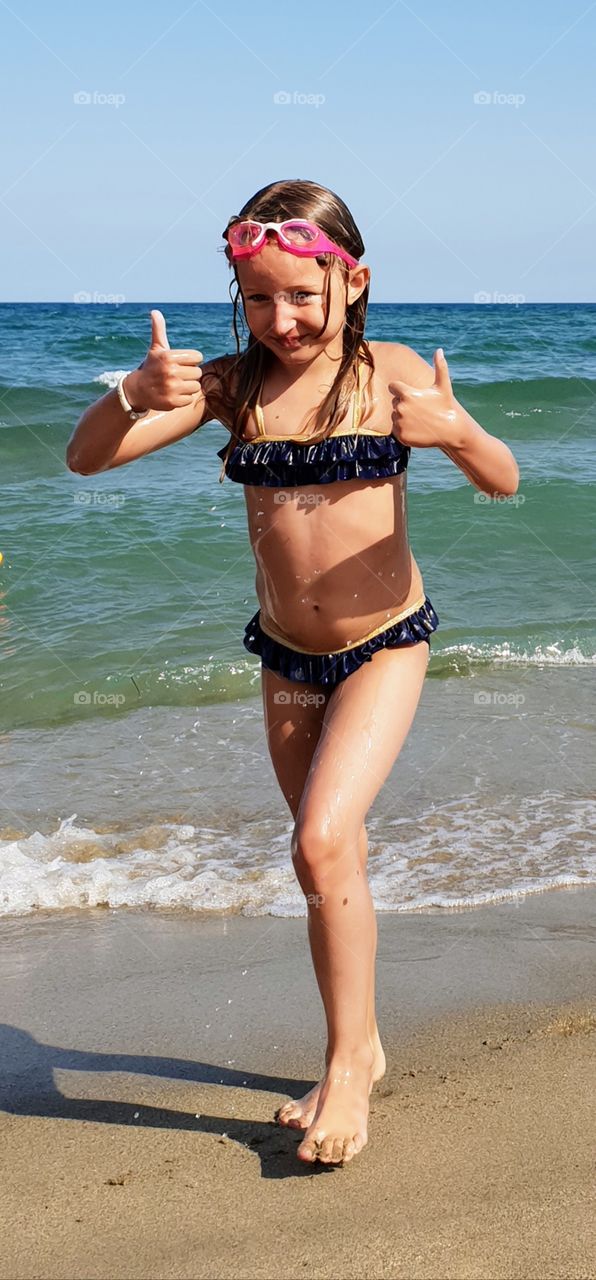 Happy girl on beach just had a swim in the ocean
