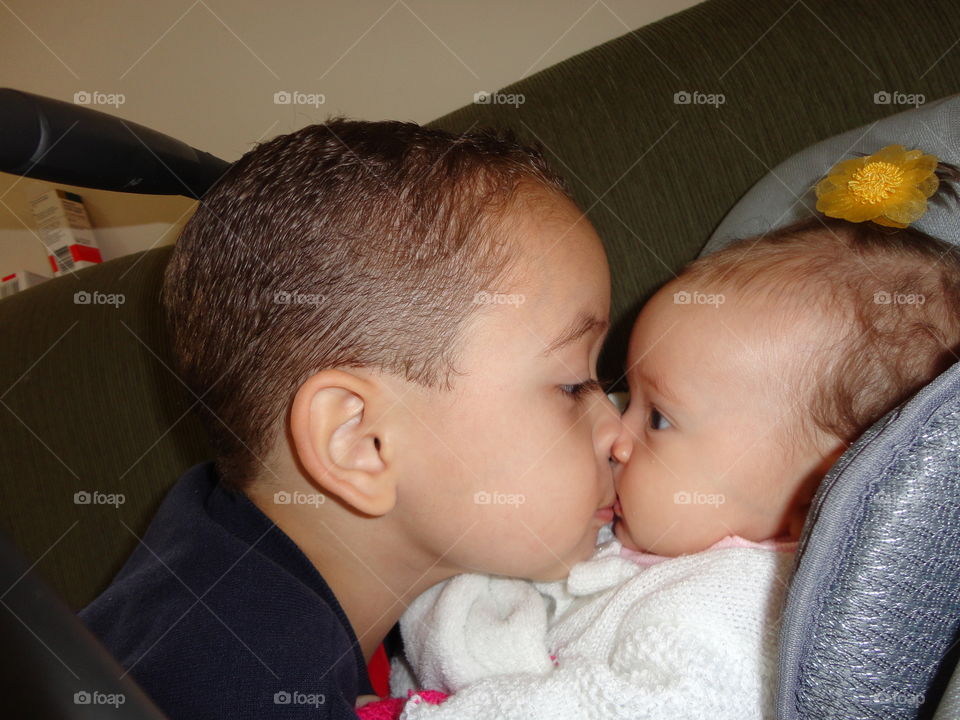 Little brother kissing his cute sister