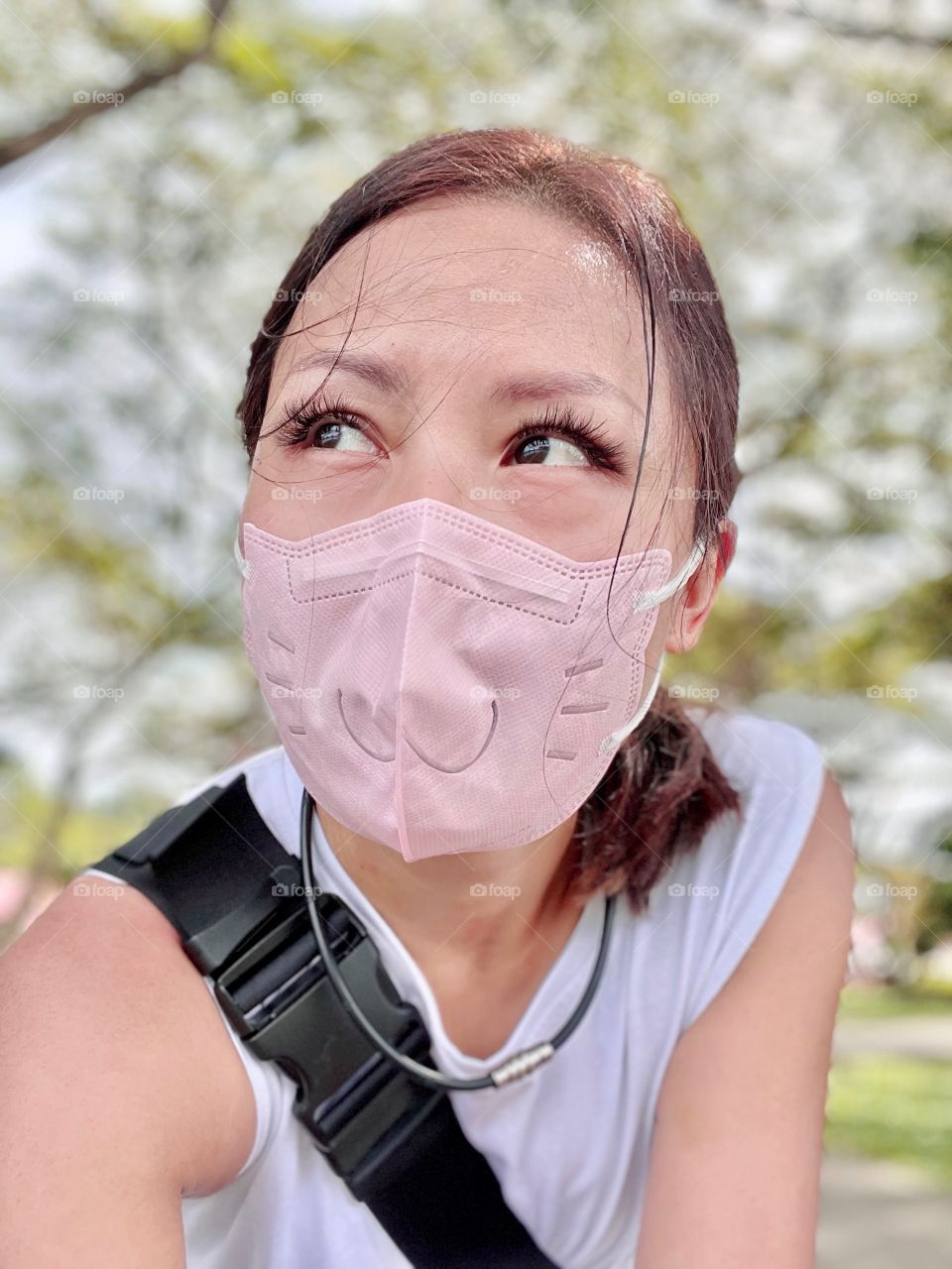 Asian woman in cute cat design disposable mask in pink 