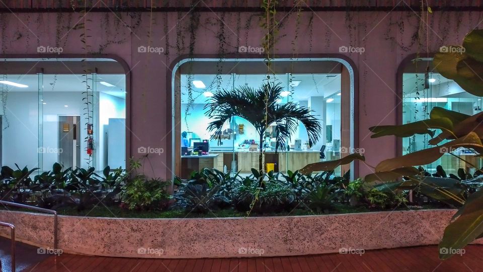 seen from outside a workspace from an office at night