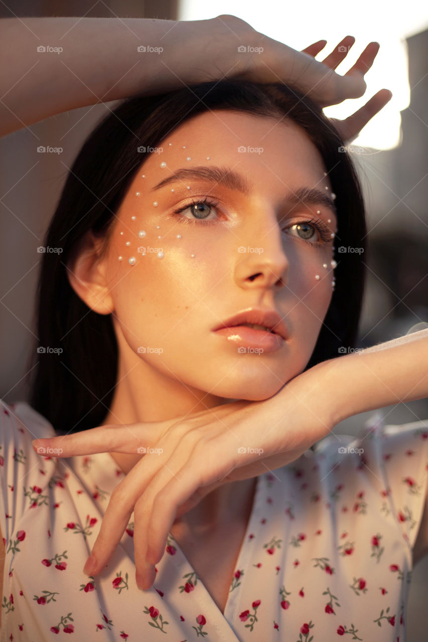 portrait photo of a young woman with bright makeup