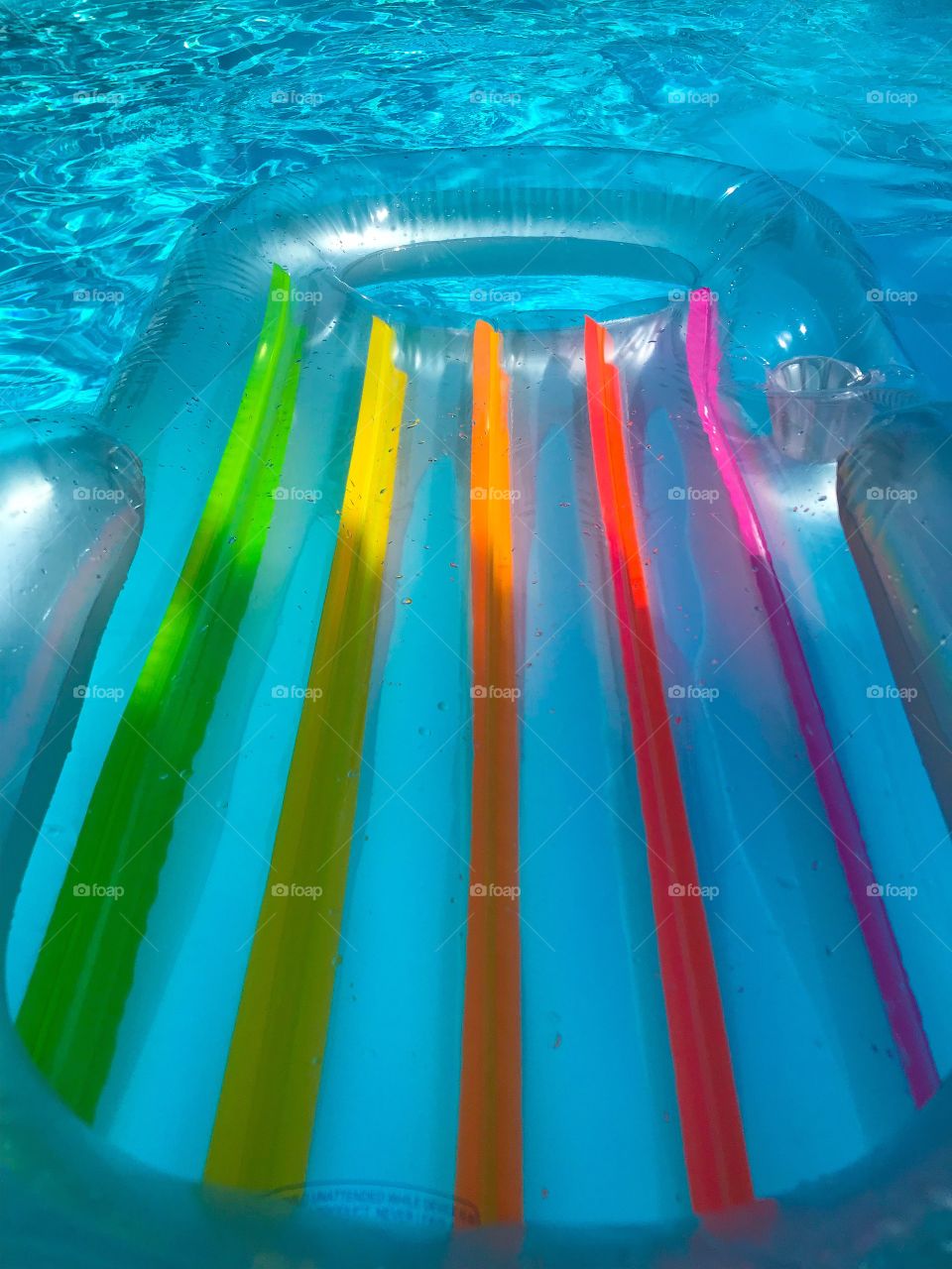 Pool side with an inflatable chair.