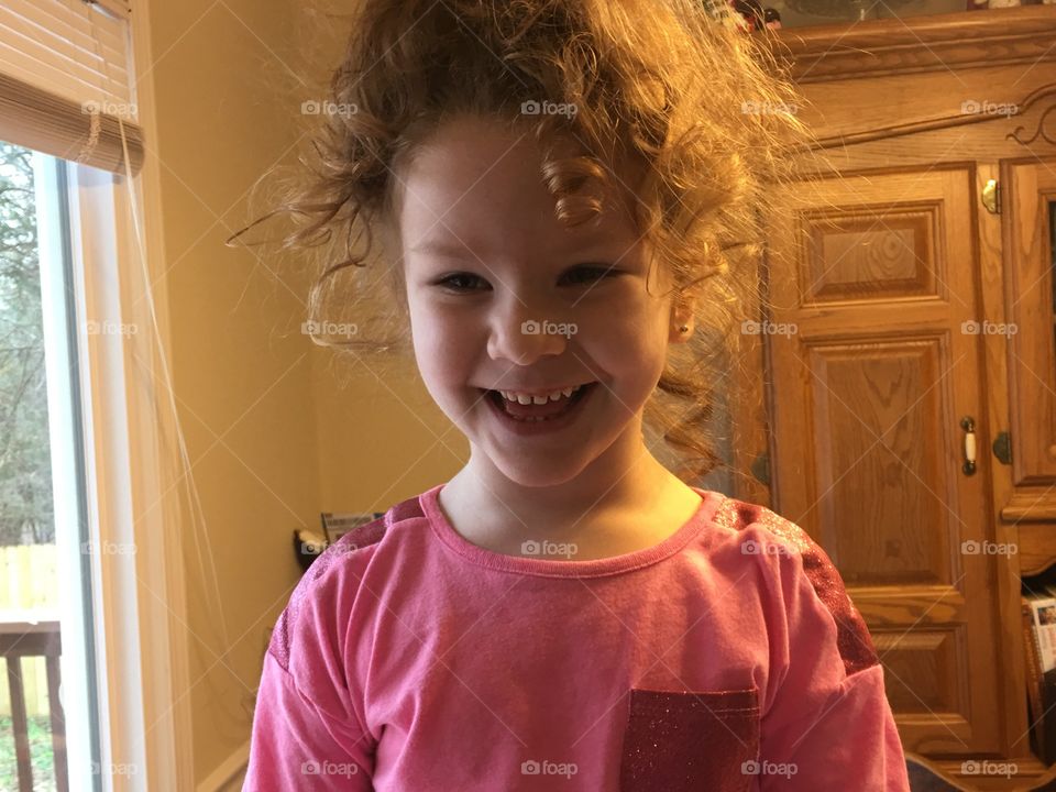Portrait of little girl smiling at home