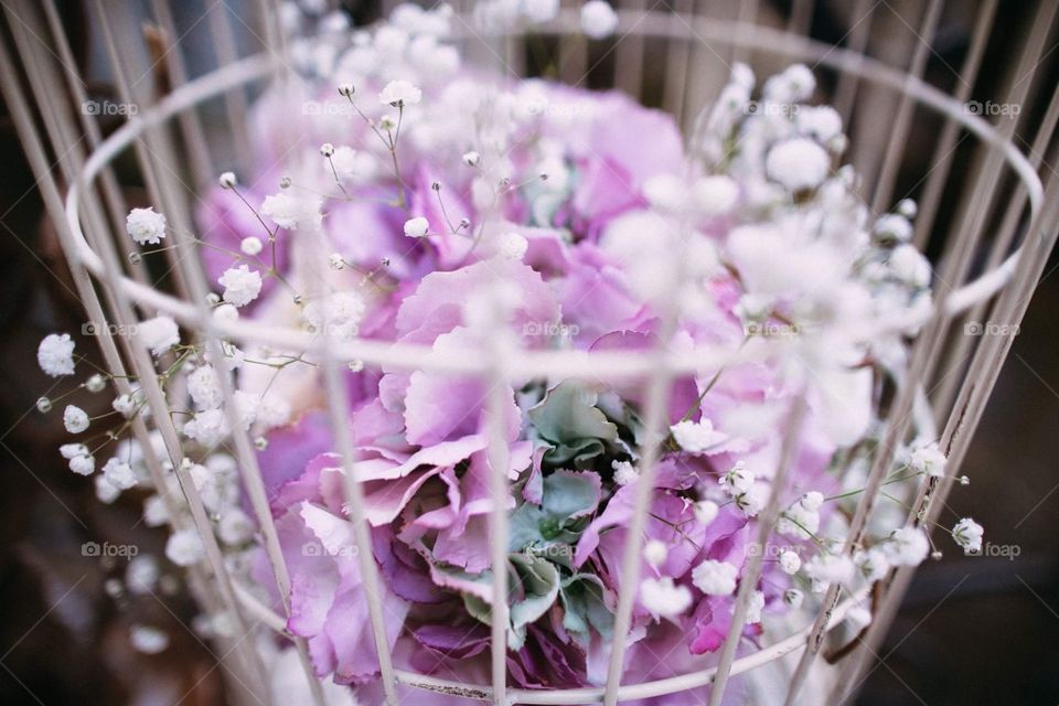 A part of a wedding ceremony venue decoration. A refined floral composition in a basket. Perfect as a background 