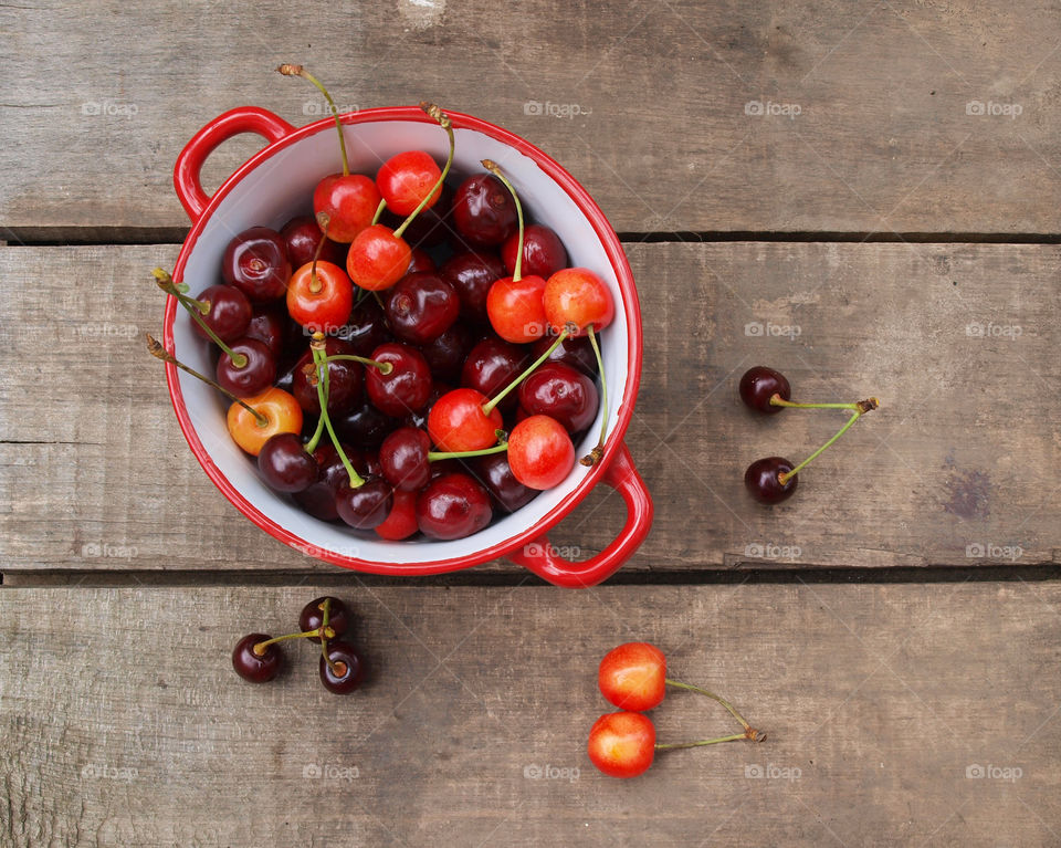 Bowl of cherries on wooden table