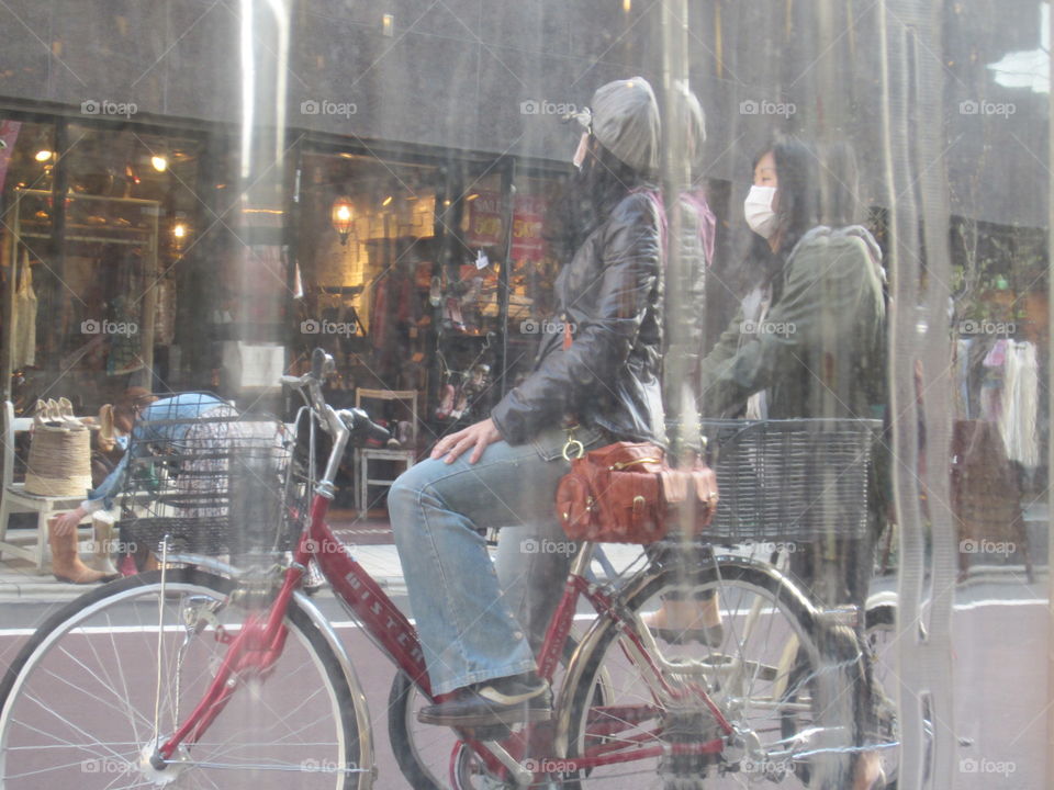 Women on Bicycle, Outside Restaurant Window.  Nakameguro, Tokyo, Japan.