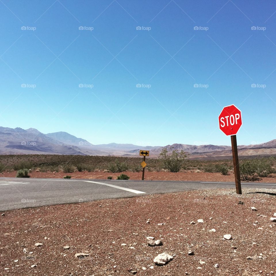 Death Valley slow sign road middle of the desert America summer sun blue sky 