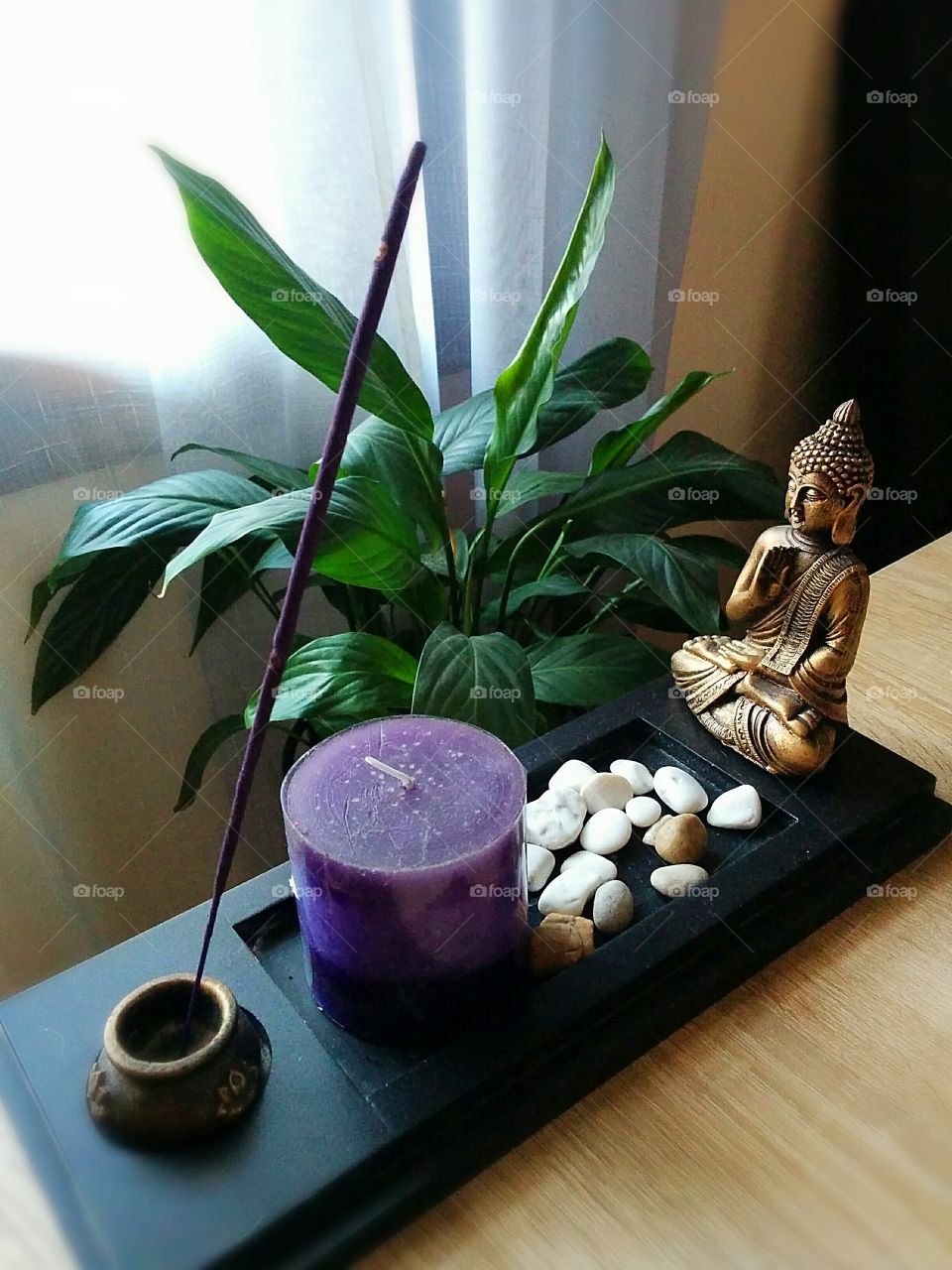 Buddha incence burner with a purple candle, and lavender burn stick.