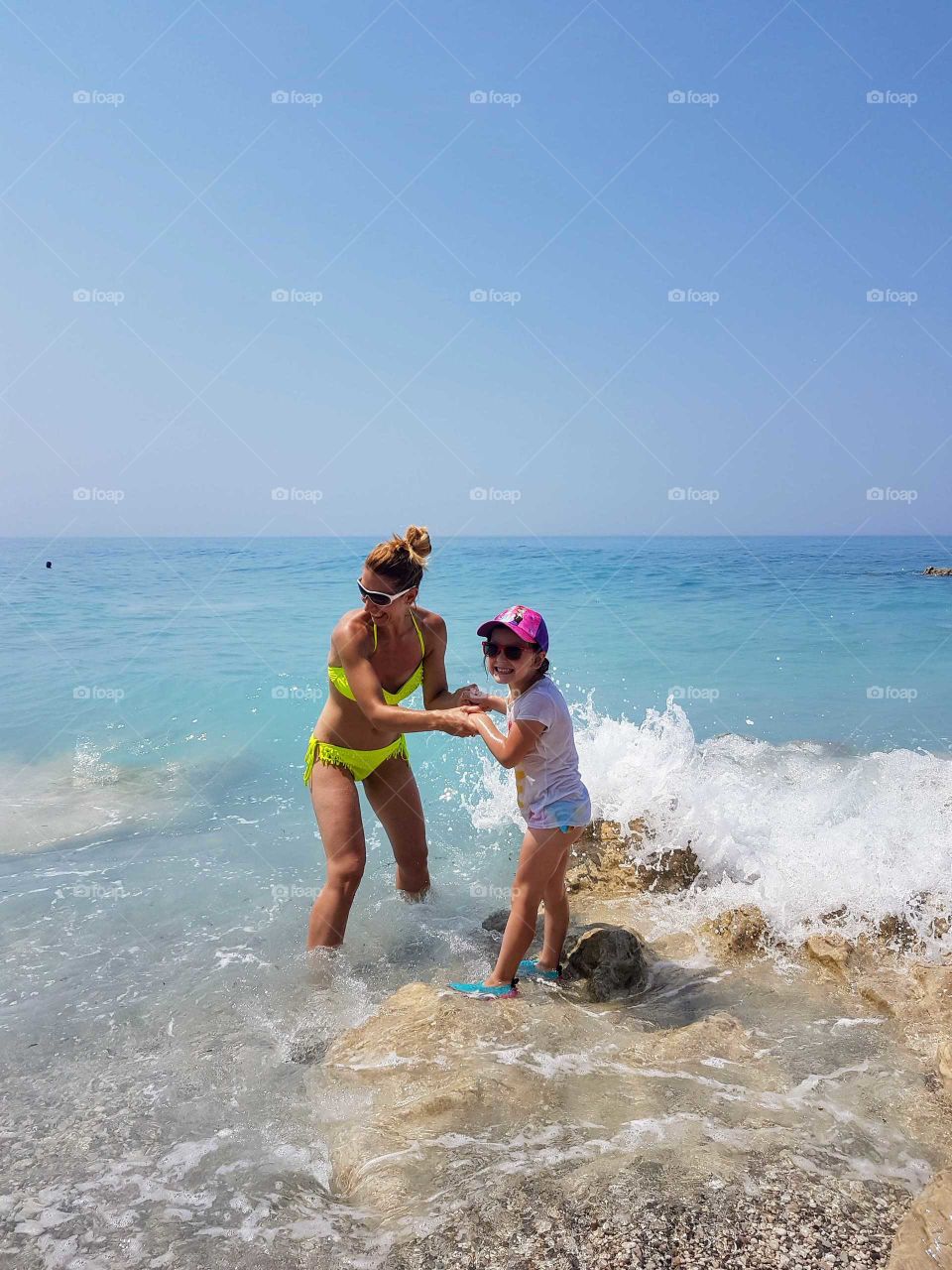 Mother and daughter enjoying the sea