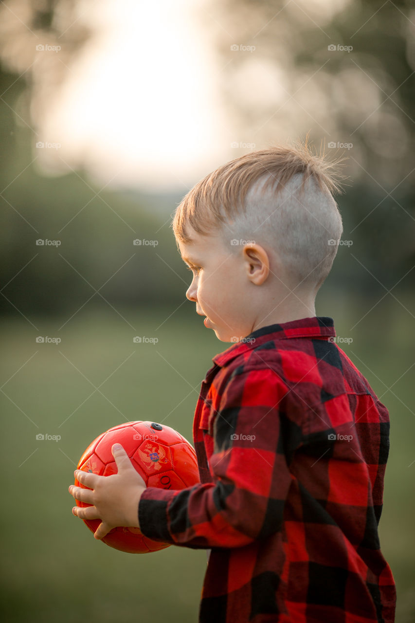 Little boy playing in soccer in a park 