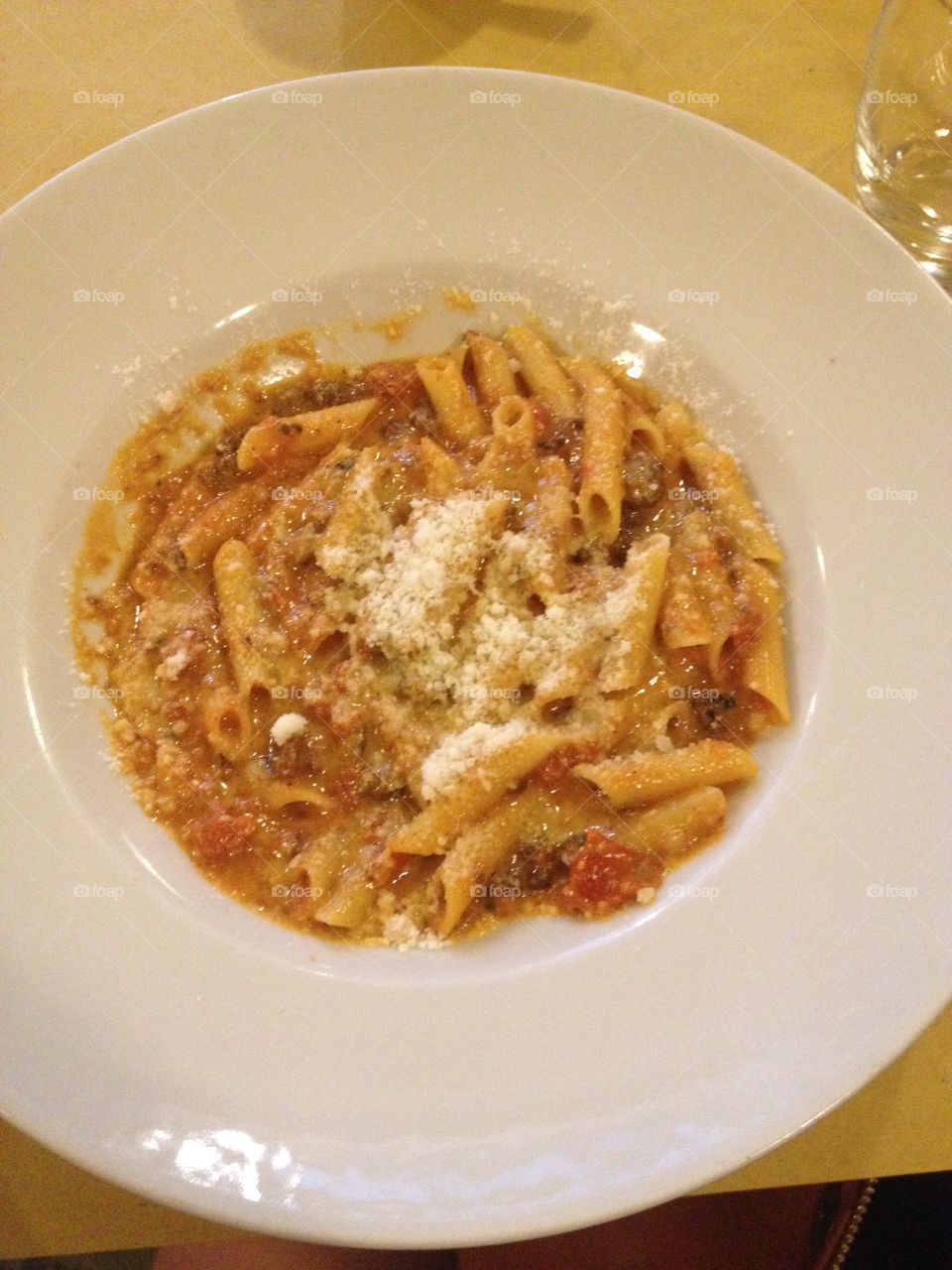 Penne pasta with parmesan  . Penne pasta with Parmesan cheese in Italy 