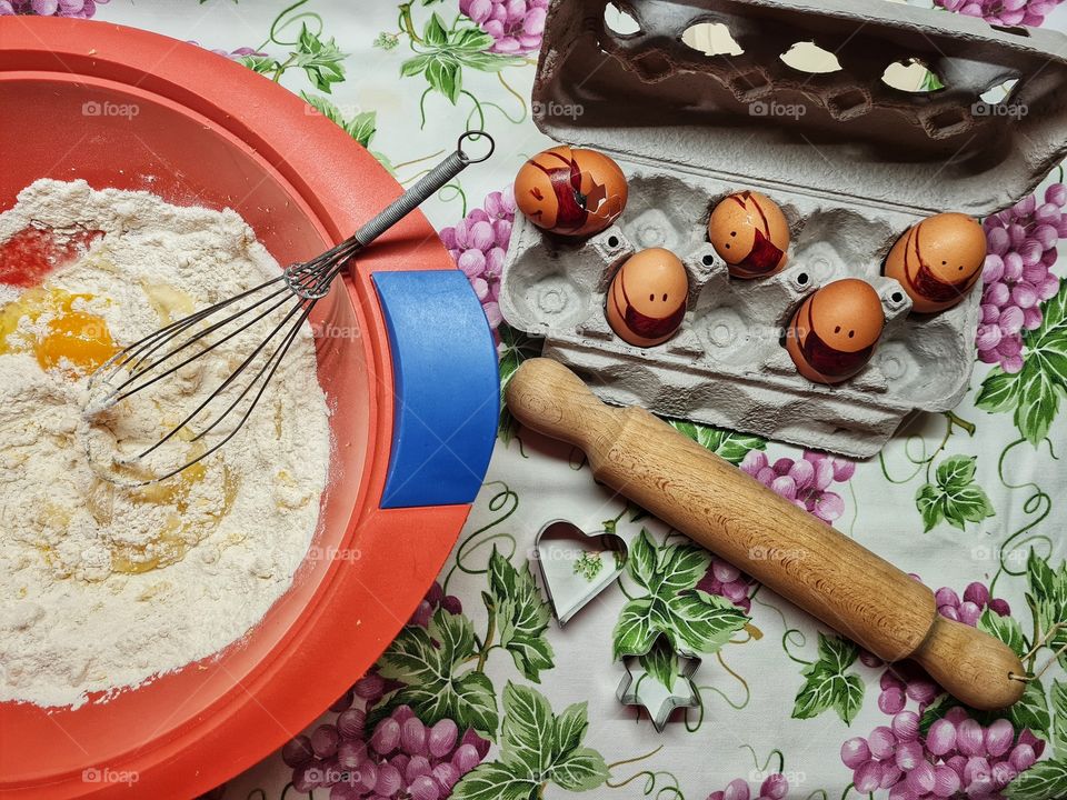 conceptual photo of eggs with protective mask used to make a dessert.This is to underline that the effects of covid-19 are now part of our daily life