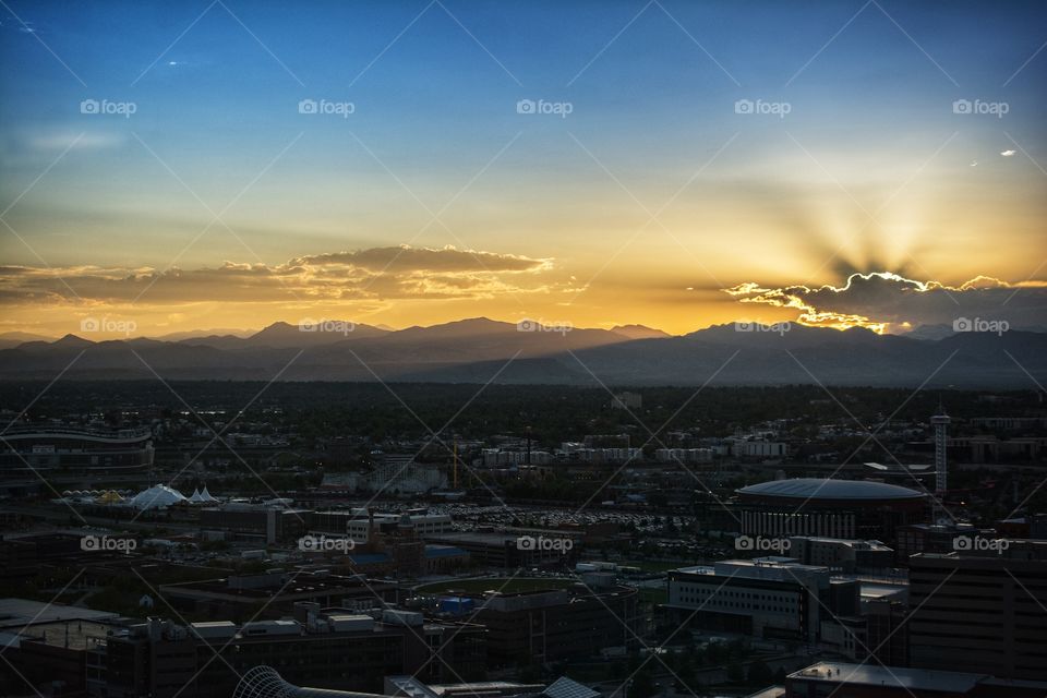 Denver Colorado Cityscape at Sunset with Mountains in the Distance 