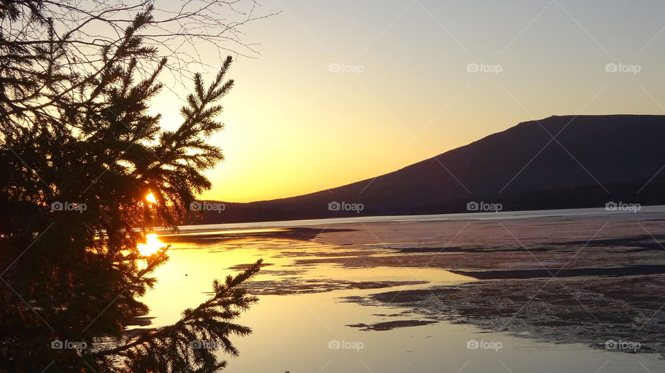 sunset on a reservoir and mountains in the Urals in Russia