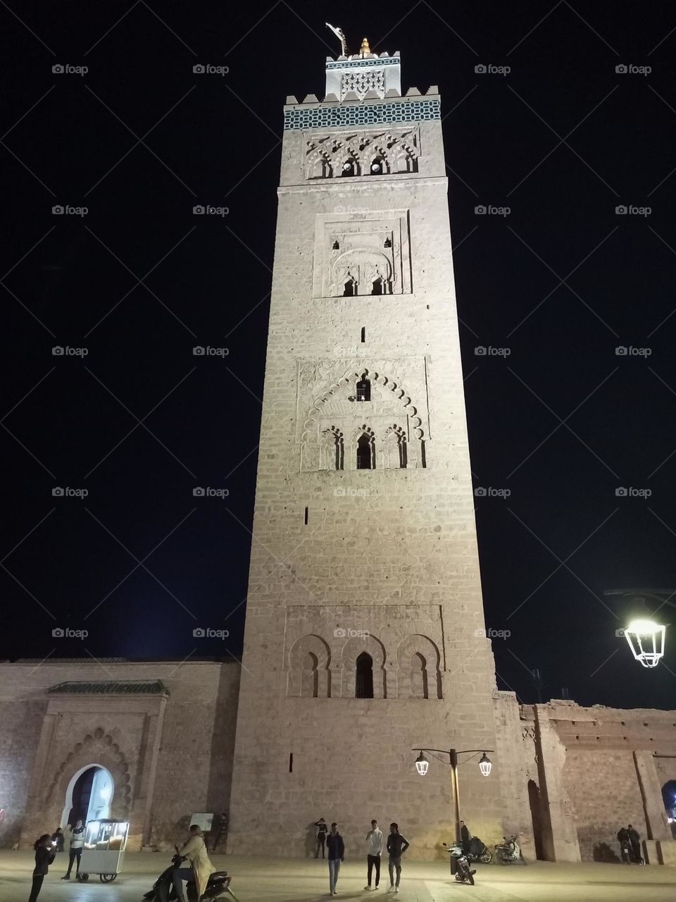 "The Koutoubia Mosque in Marrakech shines with its unique design and historical charm. Its majestic minaret stands tall, illuminated to highlight the intricate details of its stunning Islamic architecture. A symbol of spirituality and beauty, it grac