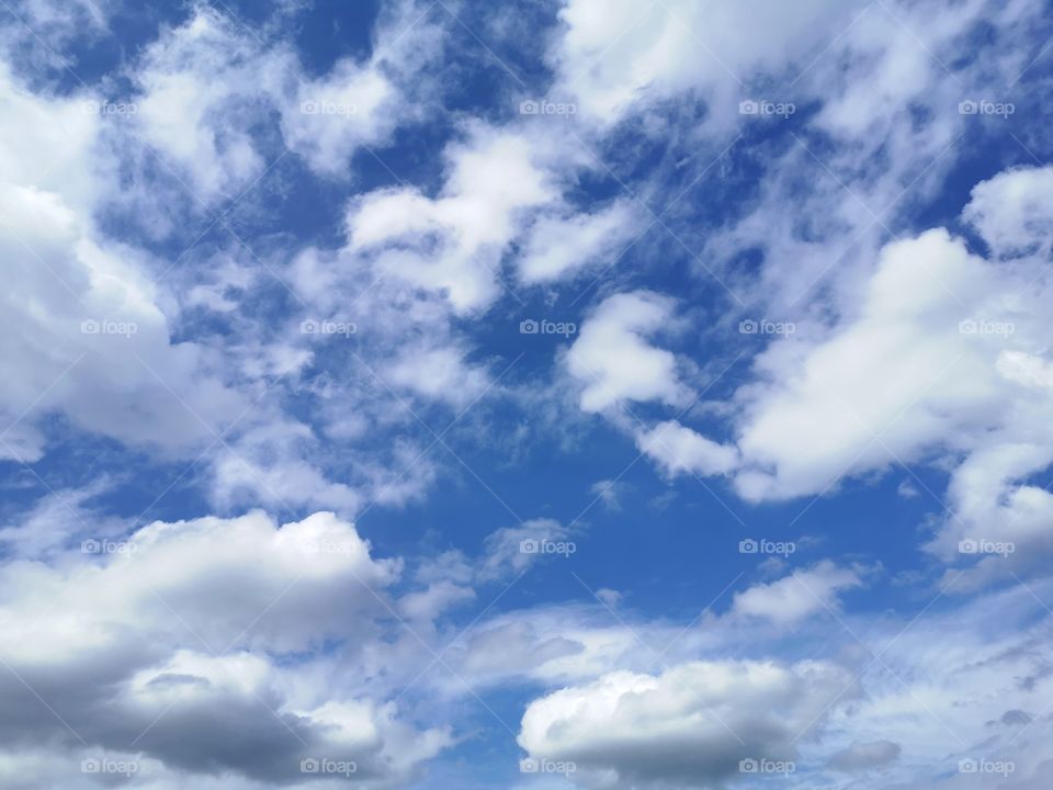 White clouds against blue sky in a beautiful morning day and nice weather.
