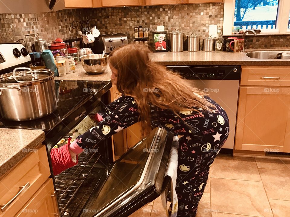 Darling girl just where she wants to be and is happy...cooking in the kitchen!! 