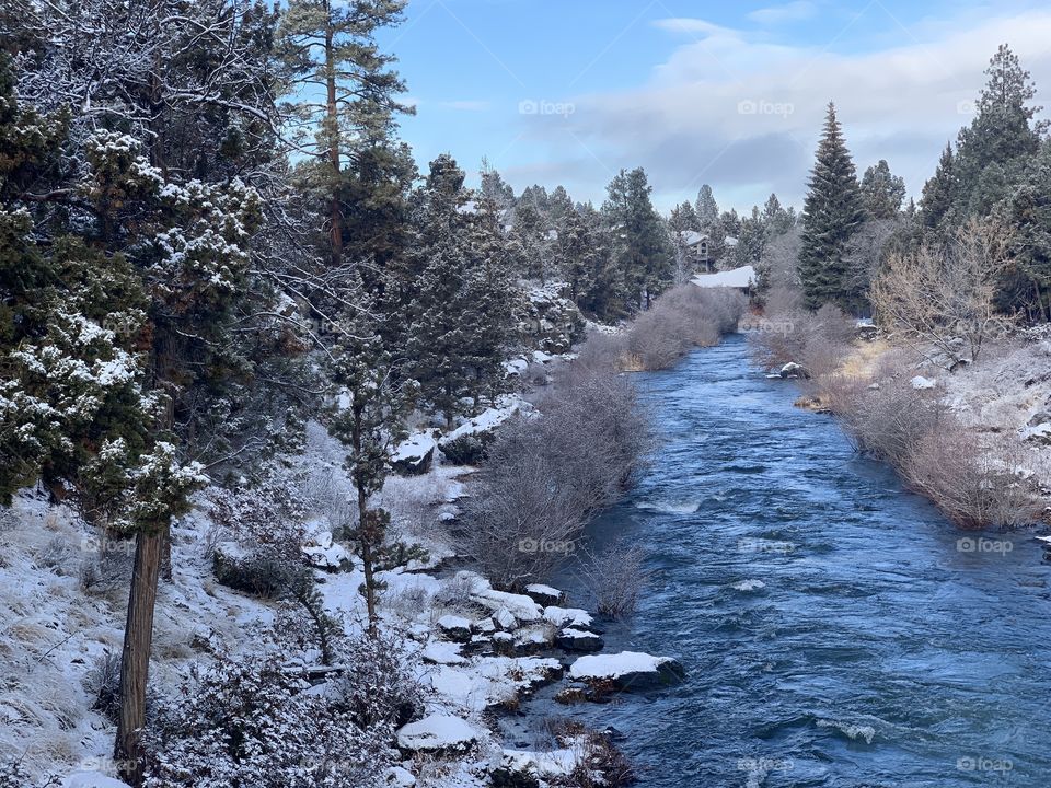 A winter wonderland of snow and a flowing river 