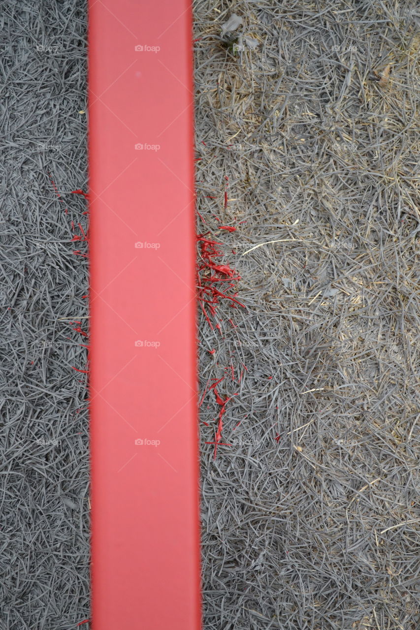 Red Wood on Gray Grass