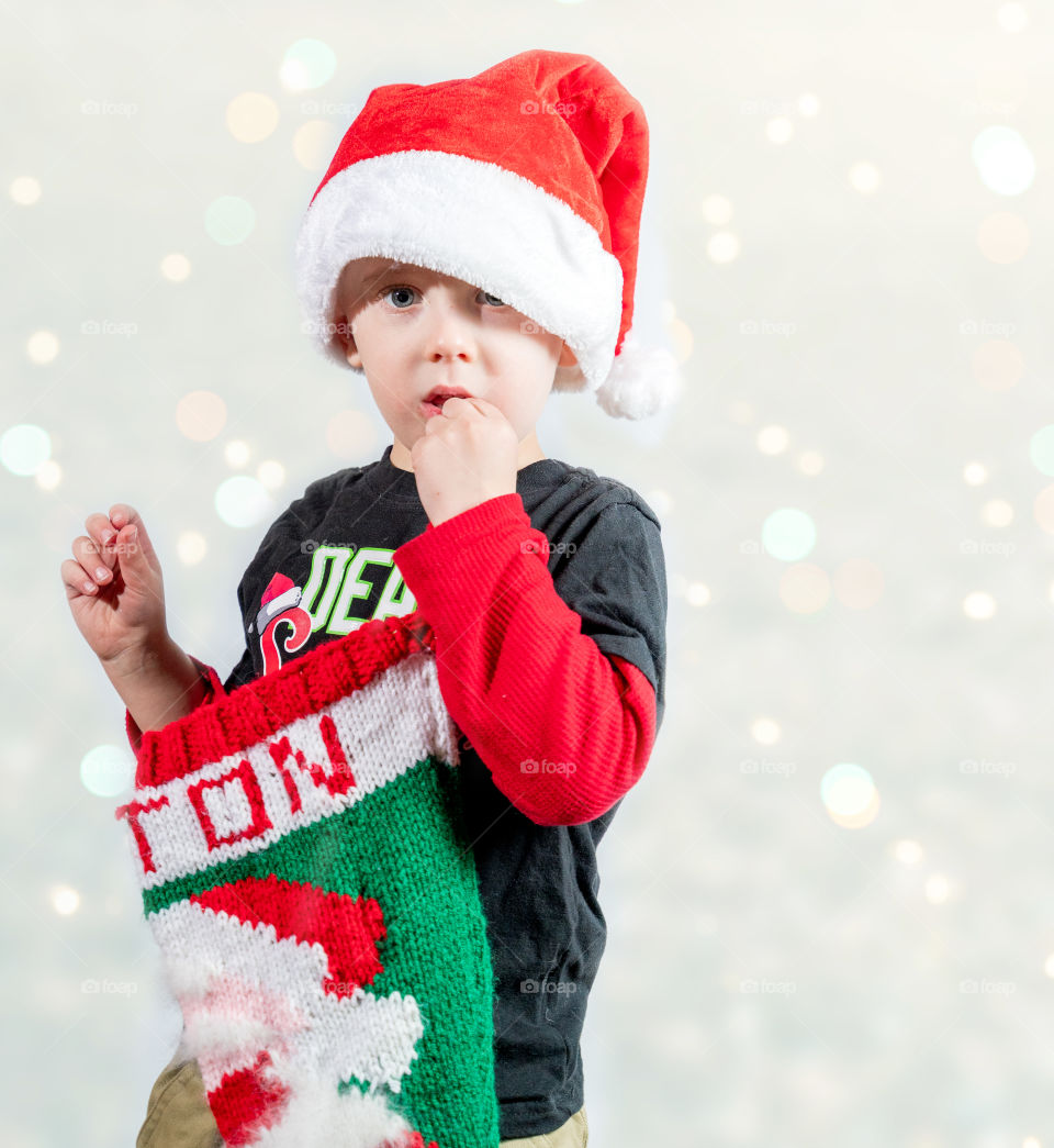 Toddler boy posing for Christmas photos