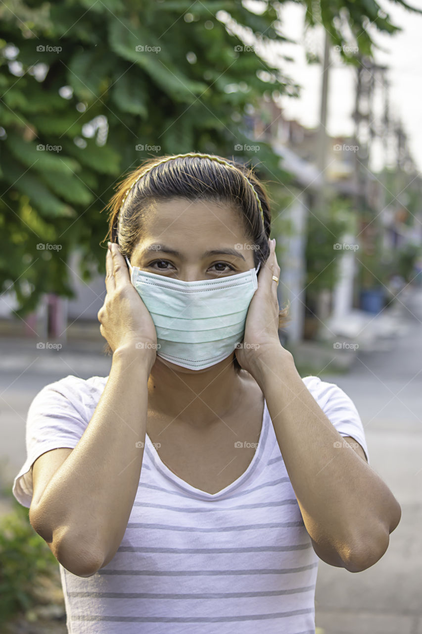 Asean Woman wear a mask to prevent dust in Bangkok ,Thailand.