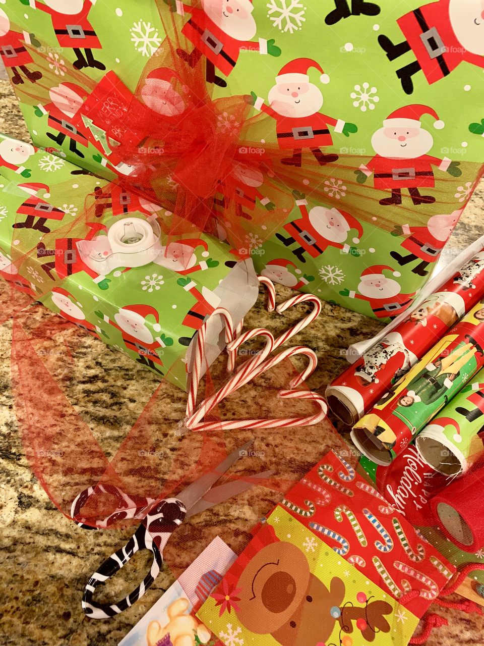 Wrapping Christmas gifts while eating candy canes and listening to Christmas music 
