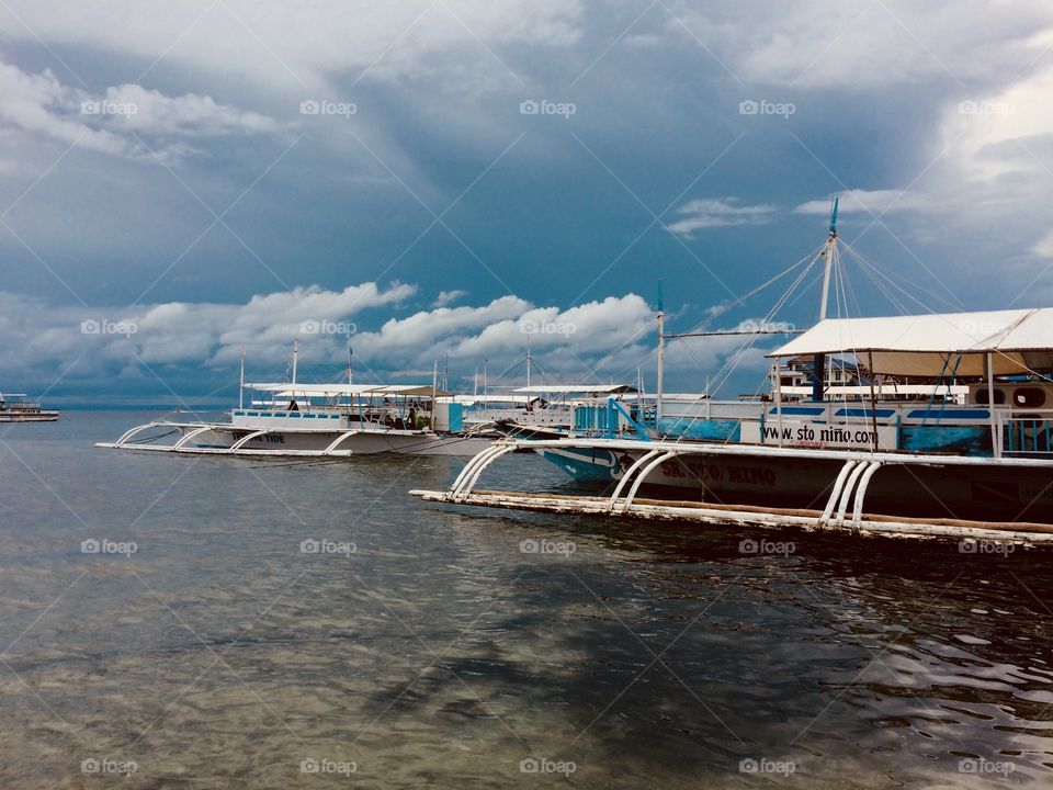Philippines. Boats in a bay on the island of Mactan.