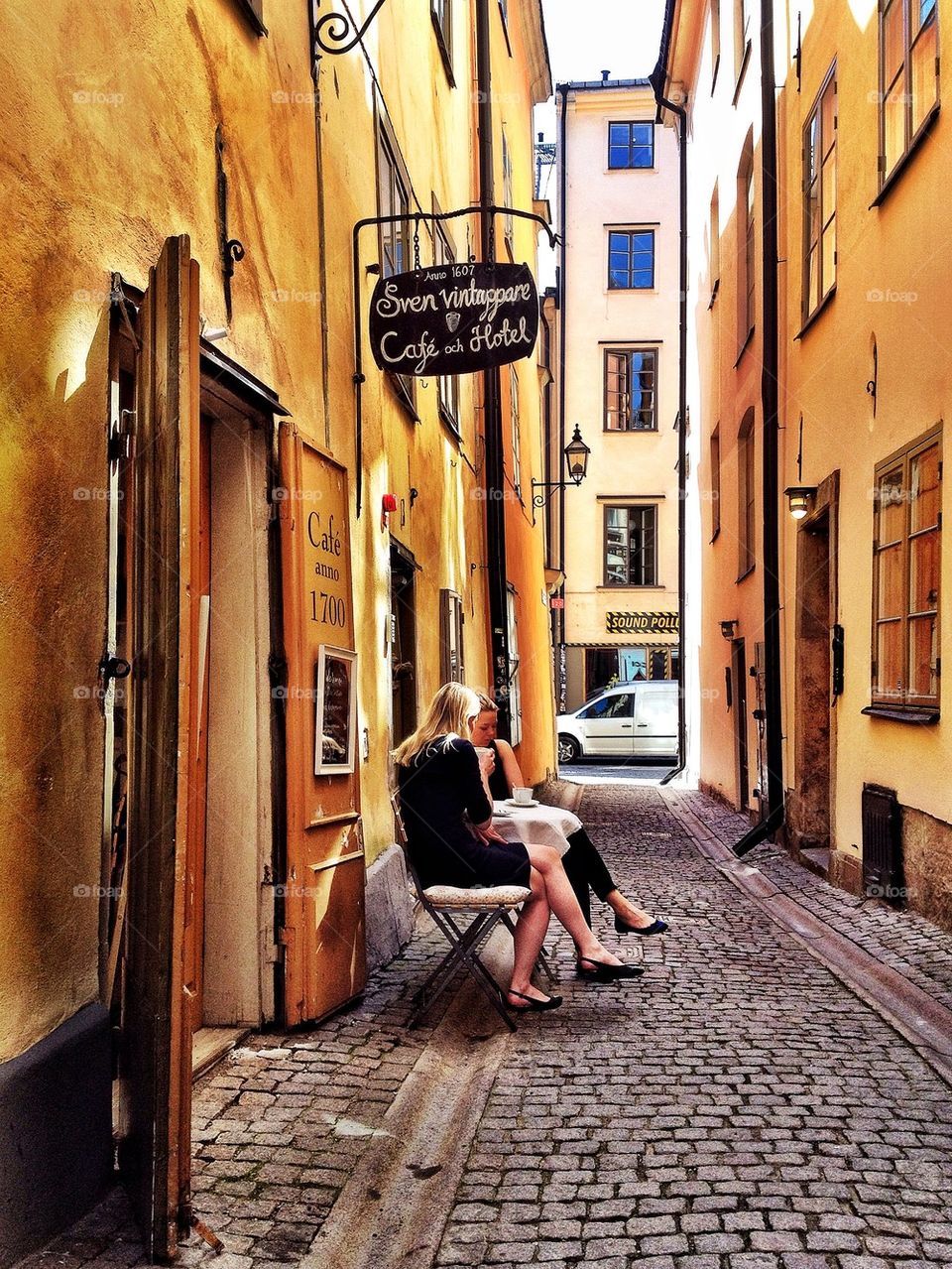 Girls having coffee in an alley