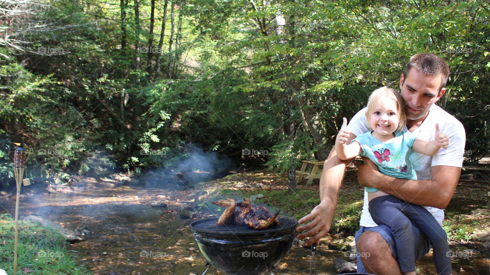 father daughter barbecuing