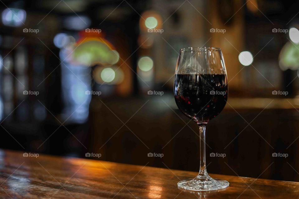 A glass of red wine on bardisk