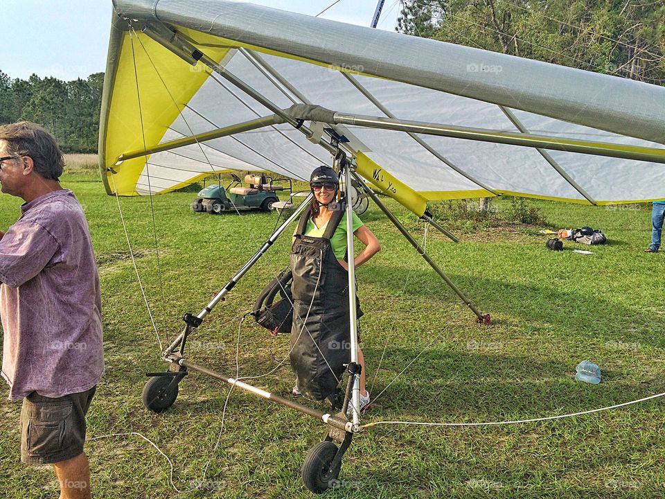 Woman in helmet with hang gilder wing