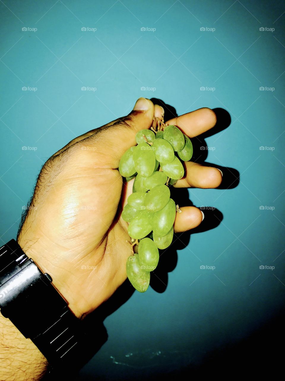 Holding the bunch of grapes