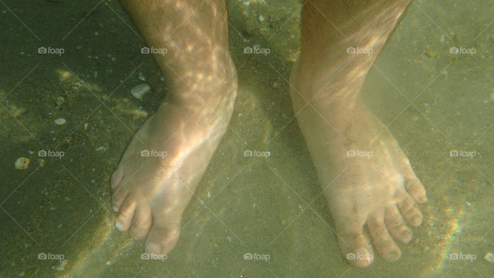 man feet underwater