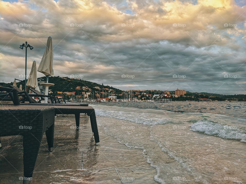 Beautiful sunset on the adriatic seaside with cloudy sky.