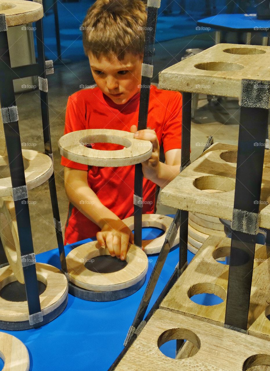 Young Architect. Young Boy Building A Structure From Various Materials
