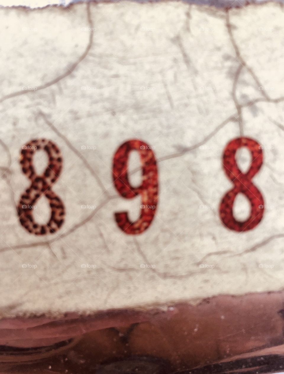 Closeup of random numbers on a cracked and peeling decal 