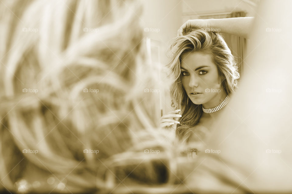 Reflection of an attractive young woman in mirror